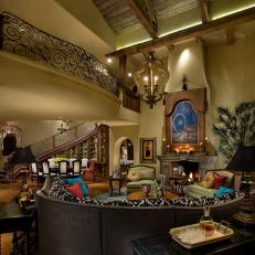 Two-Story Mediterranean Living Room With Curved Sofa