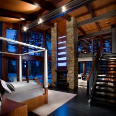 Stunning Two-Story Bedroom Features Rustic Stone Fireplace