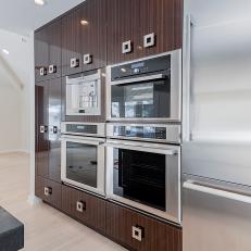 Wall of Kitchen Cabinets Features Built-In Appliances