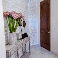 Charming Bathroom Entrance With Patterned Accent Wall
