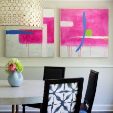 Chic Transitional Dining Room Boasts Colorful Art