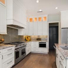 Modern Kitchen With White Cabinets and Gray Tile Backsplash 