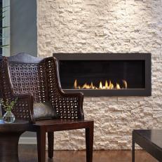 White Limestone Wall With Fireplace and Chair