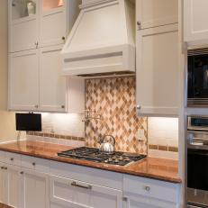 White Shaker Cabinets & Range Hood in Transitional Kitchen 