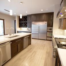 Spacious Contemporary Kitchen Features Light Hardwood and Stainless Steel Appliances 