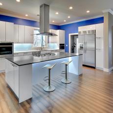Contemporary Kitchen With Bold Blue Accent Wall and Large Island 