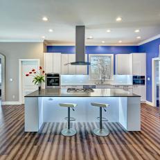 Spacious Contemporary Kitchen With Blue Accent Wall, Unique Hardwood Flooring