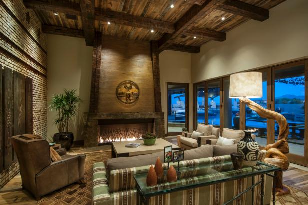 Neutral Family Room With Wood Ceiling and Large Fireplace