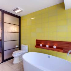 Yellow and White Asian Bathroom With Soaking Tub