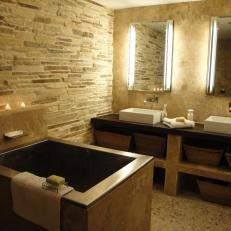 Contemporary Master Bathroom Features Stone Wall