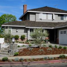 Gray Home Exterior With Neatly Mulched Front Yard