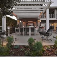 Transitional Outdoor Dining Area With White Pergola