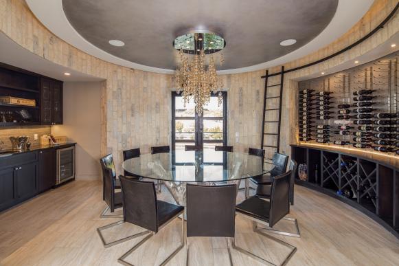 Contemporary Dining Room With Round Dining Table and Wine Racks
