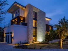 Contemporary Stone and Stucco Home Exterior at Night