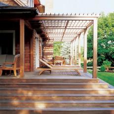 Bungalow Features Wood Deck and Attached Pergola