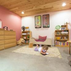 Pink Girl's Room With Light Wood Accents