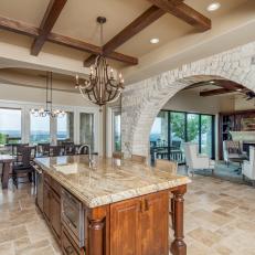 Mediterranean-Style Kitchen Features Large Stone Archway