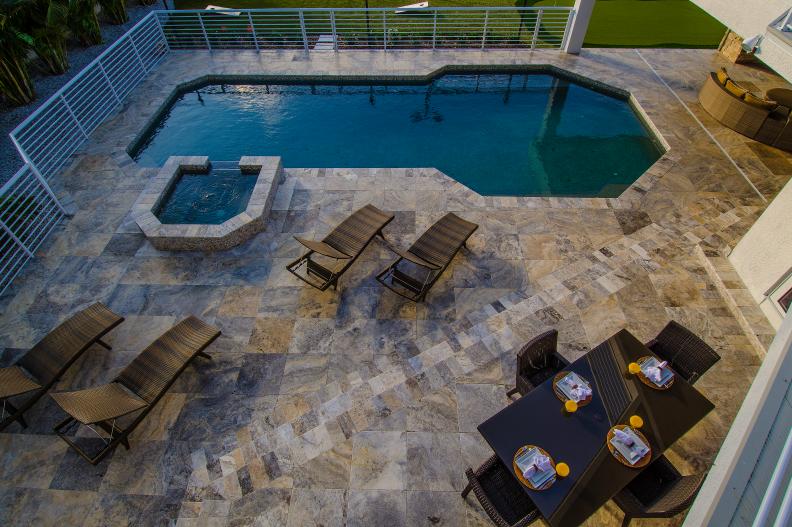 Neutral Tile Patio With Pool, Spa, Lounge Chairs and Dining Area