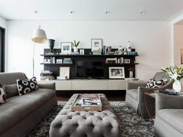 Contemporary White Living Space With Gray Furniture, Black Shelving
