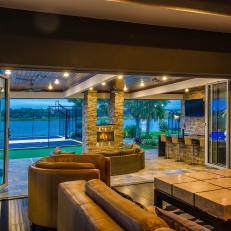 Plush Seating Overlooks Patio with Fireplace and Basketball Court