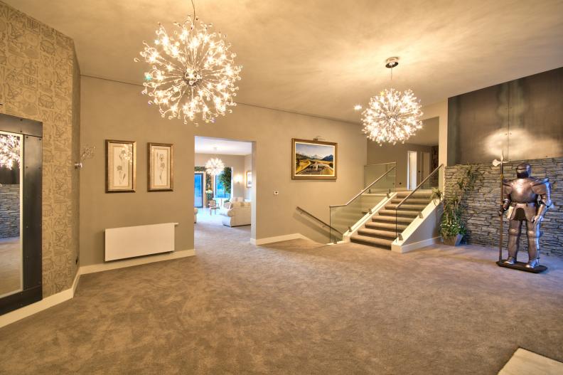 Neutral Transitional Entryway With Glass Pendants & Carpet