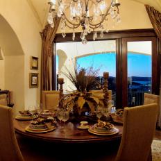 Transitional Dining Room With Crystal Chandelier & Layered Place Settings 