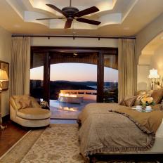 Gorgeous Golden Bedroom With Plush Bed Linens and Backyard View 