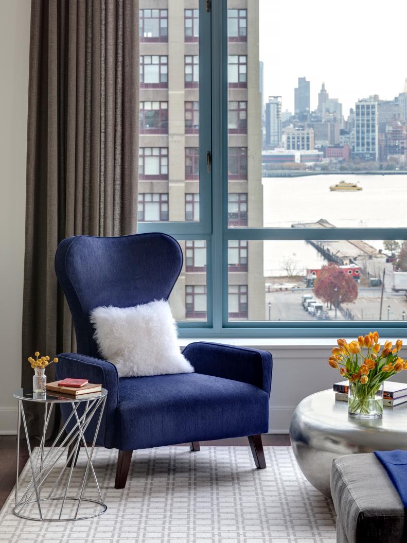 Navy Blue Wingback Chair With Furry Accent Pillow and City View