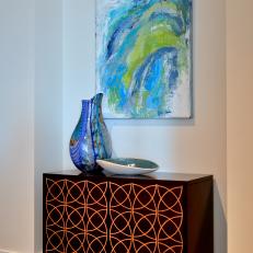 Etched Wood Cabinet With Decorative Vase and Abstract Painting 