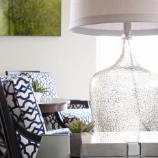 Contemporary End Table With Glass Lamp and Blue Patterned Chairs 