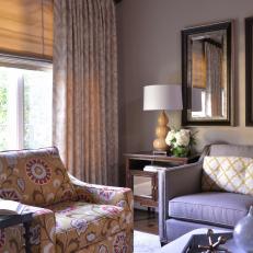 Sitting Room Features Floral Mustard Yellow Armchair and Layered Window Treatments