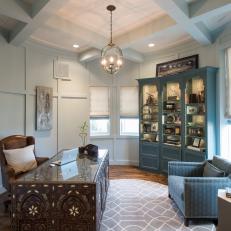 Transitional Home Office With Decorative Moroccan Desk and Large Blue Bookshelf 