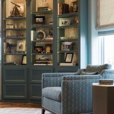 Sophisticated Study With Light Blue Shelving & Contemporary Armchair
