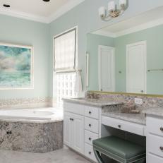 Spa Bathroom With Gray Marble, Corner Bathtub and White Vanity