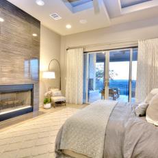 Luxurious Master Bedroom With Polished Stone Fireplace Surround 