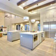 Open, Contemporary Kitchen With Twin Islands & Exposed Beams