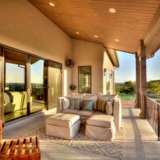 Covered Porch at Sunrise Features Comfy Beige Sofa