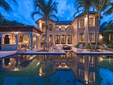 Mediterranean Exterior at Night With Pool & Palm Trees