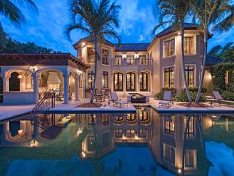 Mediterranean Exterior at Night With Pool & Palm Trees