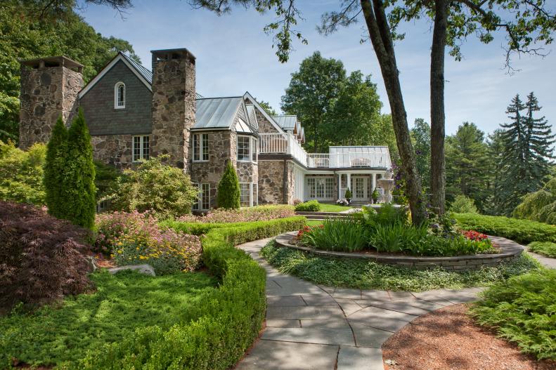 Traditional Stone Mansion Exterior With Landscaped Yard
