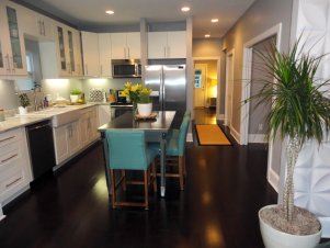 New, White Cabinets and Stainless Steel Dining Table in Bright, Contemporary Kitchen