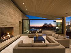 Contemporary Great Room With Rammed Earth Wall and Sliding Glass Doors