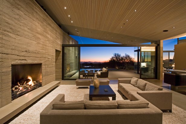 Contemporary Great Room With Rammed Earth Wall and Sliding Glass Doors