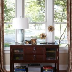 Wooden Storage Console Framed by Windows