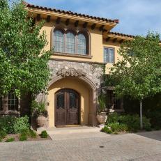 Neutral Mediterranean Entrance with Arched Wood Doors 