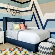 Contemporary Bedroom With Striped Walls & Deep Blue Bed