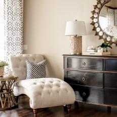 White Tufted Chaise and Black Dresser