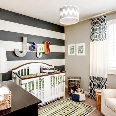 Transitional Boy's Nursery With Black and White Striped Accent Wall