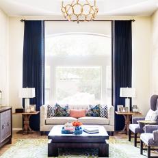 Neutral Transitional Living Room With Blue Curtains