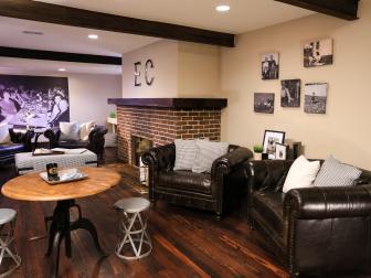 Basement Room with Brown Sofas, Hardwood Floors and Brick Fireplace